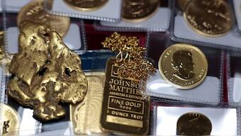 In this photo illustration, a one-ounce gold bar, a gold nugget, and gold coins are displayed at Witter Coins on October 07, 2025 in San Francisco, California. AFP