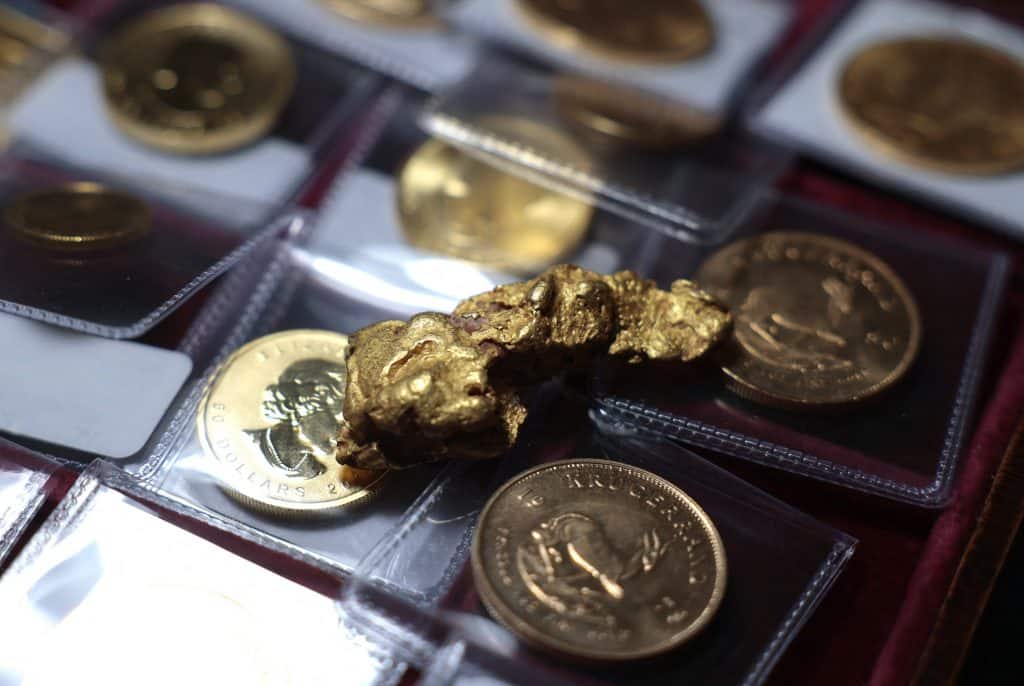In this photo illustration, a gold nugget sits on top of gold coins at Witter Coins on October 07, 2025 in San Francisco, California. AFP
