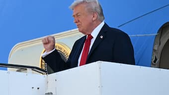 US President Donald Trump gestures as he disembarks from Air Force One upon arrival at Ben Gurion Airport on the outskirts of Lod near Tel Aviv on October 13, 2025, as he travels to Israel and Egypt. Trump is passing through Israel, addressing parliament and meeting with hostage families before heading to Egypt's Sharm El-Sheikh for a major peace summit, where a "document ending the war in the Gaza Strip" is expected to be signed. (Photo by SAUL LOEB / AFP)