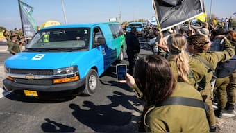 Vehicles carrying hostages who were released by Hamas from the Gaza Strip arrive to the Reim military base near the border with Gaza in southern Israel on October 13, 2025. AFP