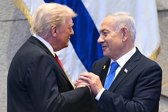 US President Donald Trump (L) holds hands and speaks with Israeli Prime Minister Benjamin Netanyahu. Image Credit: AFP