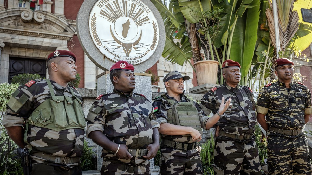 Malagasy Colonel Michael Randrianirina (C), head of the CAPSAT military unit, stands with other members of the unit after reading out a statement in front of the presidential palace where he announced they are taking power in Antananarivo on October 14, 2025. An elite Madagascar military unit told AFP on October 14, 2025 it had taken power in the country after the national assembly voted to impeach President Andry Rajoelina for desertion of duty. (Photo by Luis TATO / AFP) Malagasy Colonel Michael Randrianirina (C), head of the CAPSAT military unit, stands with other members of the unit after reading out a statement in front of the presidential palace where he announced they are taking power in Antananarivo on October 14, 2025. An elite Madagascar military unit told AFP on October 14, 2025 it had taken power in the country after the national assembly voted to impeach President Andry Rajoelina for desertion of duty. (Photo by Luis TATO / AFP)