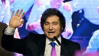 Argentina's President Javier Milei waves to supporters at the ruling party's La Libertad Avanza headquarters following the results of the national midterm legislative election in Buenos Aires on October 26, 2025. AFP