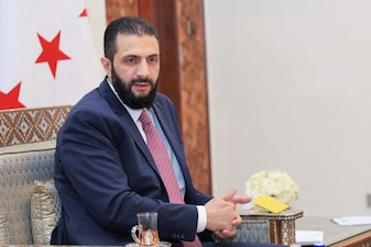 (File) In this photo released by the Syrian official news agency SANA, Syria's interim President Ahmad al-Sharaa receives the final version of the provisional electoral system for the People's Assembly, in Damascus, Syria, Sunday, July 27, 2025. AP