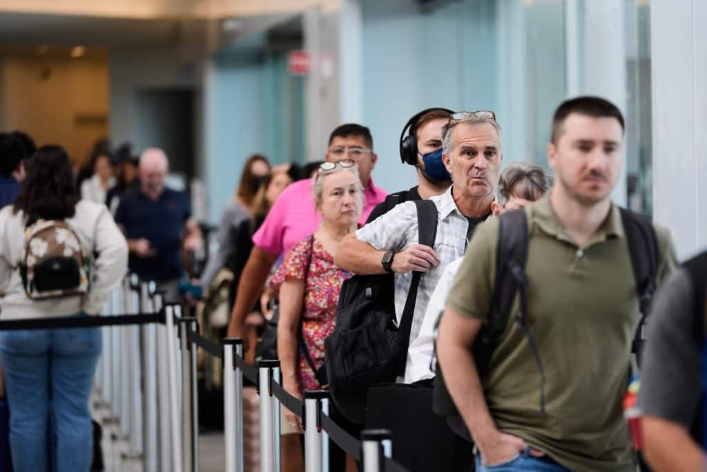 Travelers wait in line for screening at Louis Armstrong New Orleans International Airport in Kenner, La. AP