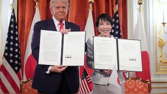 President Donald Trump (left) and Japan's Prime Minister Sanae Takaichi (right) pose with their documents during a signing ceremony at Akasaka Palace in Tokyo, Japan. AP