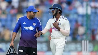 B Sai Sudharsan leaves the field along with a member of the medical team after completing a catch at short leg to dismiss John Campbell on Day 2 of the second Test between India and West Indies in Delhi. AP