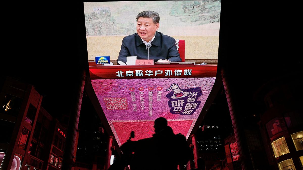 A man rides a scooter past a giant screen showing news footage of Chinese President Xi Jinping attending a Chinese Communist Party politburo meeting, in Beijing, China, December 9, 2024. File Image/Reuters A man rides a scooter past a giant screen showing news footage of Chinese President Xi Jinping attending a Chinese Communist Party politburo meeting, in Beijing, China, December 9, 2024. File Image/Reuters