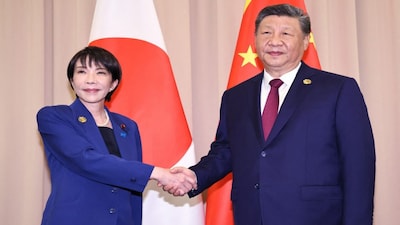 Japan's Prime Minister Sanae Takaichi (left) shakes hands with Chinese President Xi Jinping. AFP File