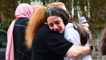 Members of the community comfort each other near Heaton Park Hebrew Congregation Synagogue in Crumpsall, north Manchester, England, on October 2, 2025, after a terrorist attack at the synagogue. (Photo: Paul Currie/AFP)