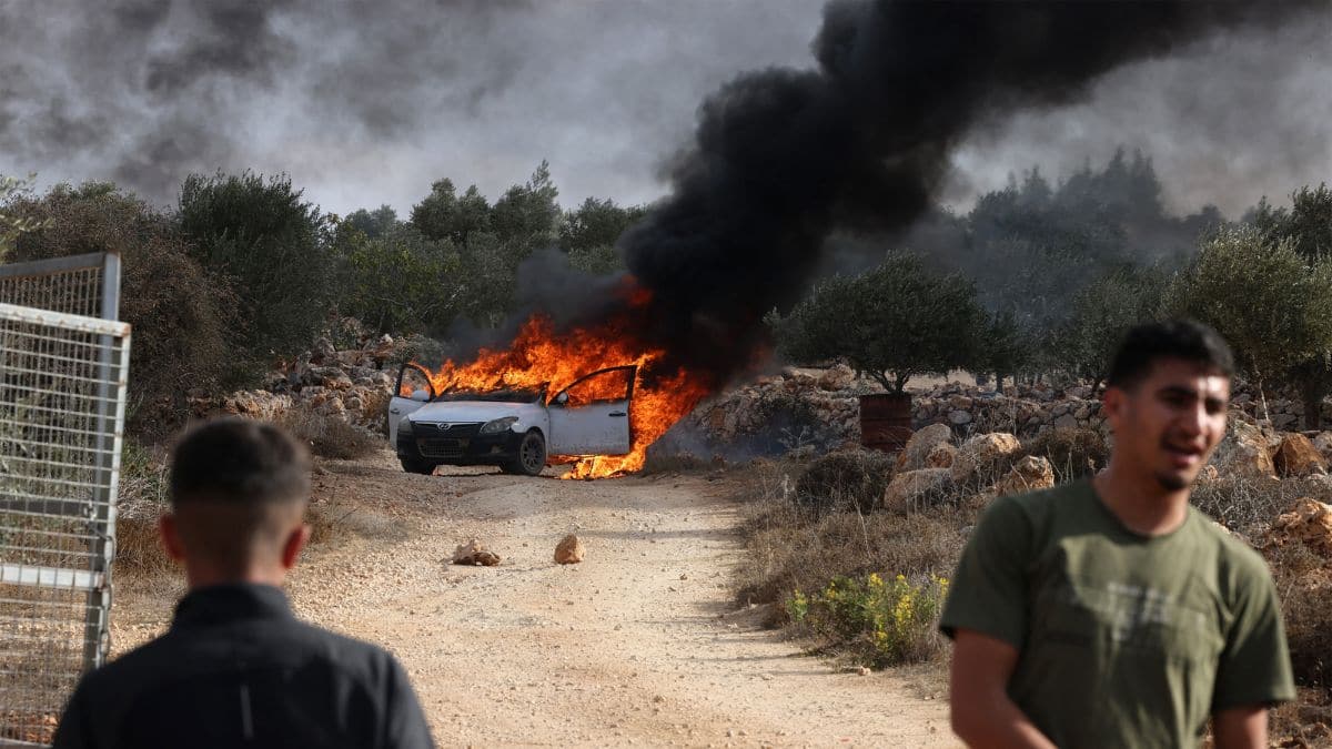 Watch: Israeli settlers attack Palestinian olive farmers in West Bank, torch cars