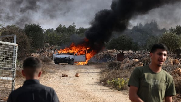 Watch: Israeli settlers attack Palestinian olive farmers in West Bank, torch cars