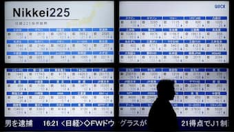 A man walks past an electronic board showing Japan's Nikkei 225 outside a brokerage in Tokyo, Japan, on January 12, 2016. (Representational Image, Credit: Toru Hanai/Reuters) 