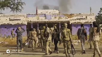 This image grab taken from handout video footage released on Sudan's Rapid Support Forces (RSF) Telegram account on October 26, 2025, shows RSF fighters holding weapons and celebrating in the streets of El-Fasher in Darfur region. (Photo: RSF/AFP) 