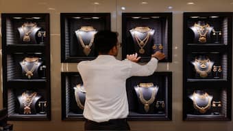 An employee arranges gold necklaces at a jewellery store in Mumbai on March 20, 2025. Reuters File