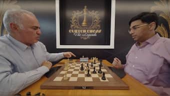 Garry Kasparov points towards the clock during Game 5 against Viswanathan Anand in Clutch Chess: The Legends. Image credit: Screengrab/chess24 