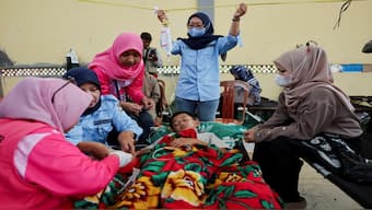 Muhammad Setiawan Pratama, 11, an elementary student receives treatment for food poisoning after eating government-sponsored free school meals, at a makeshift clinic inside a district's hall in Bandung, West Java province, Indonesia, on September 25, 2025. Reuters File