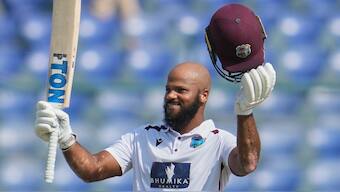 West Indian opener John Campbell celebrates after completing his maiden Test hundred on Day 4 of the second Test in New Delhi. AP