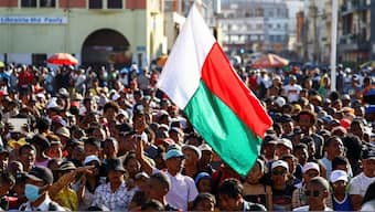 A protester waves his country's flag as demonstrators gather outside the town hall on Independence Avenue during a nationwide youth-led protest over frequent power outages and water shortages, in Antananarivo, Madagascar, October 13, 2025. File Image/Reuters