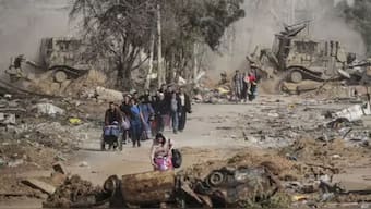 Palestinians flee south via Salah al-Din Road, in central Gaza, on the third day of a temporary ceasefire between Israel and Hamas on November 26, 2023. File Photo- AP
