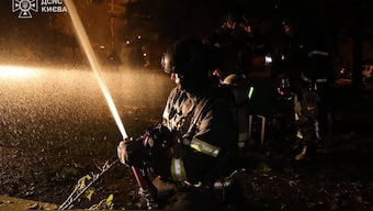 In this handout photograph taken and released by the Ukrainian Emergency Service on October 22, 2025, Ukrainian rescuers work to extinguish a fire at the site of an air strike in Kyiv, amid the Russian invasion of Ukraine. Image- AFP