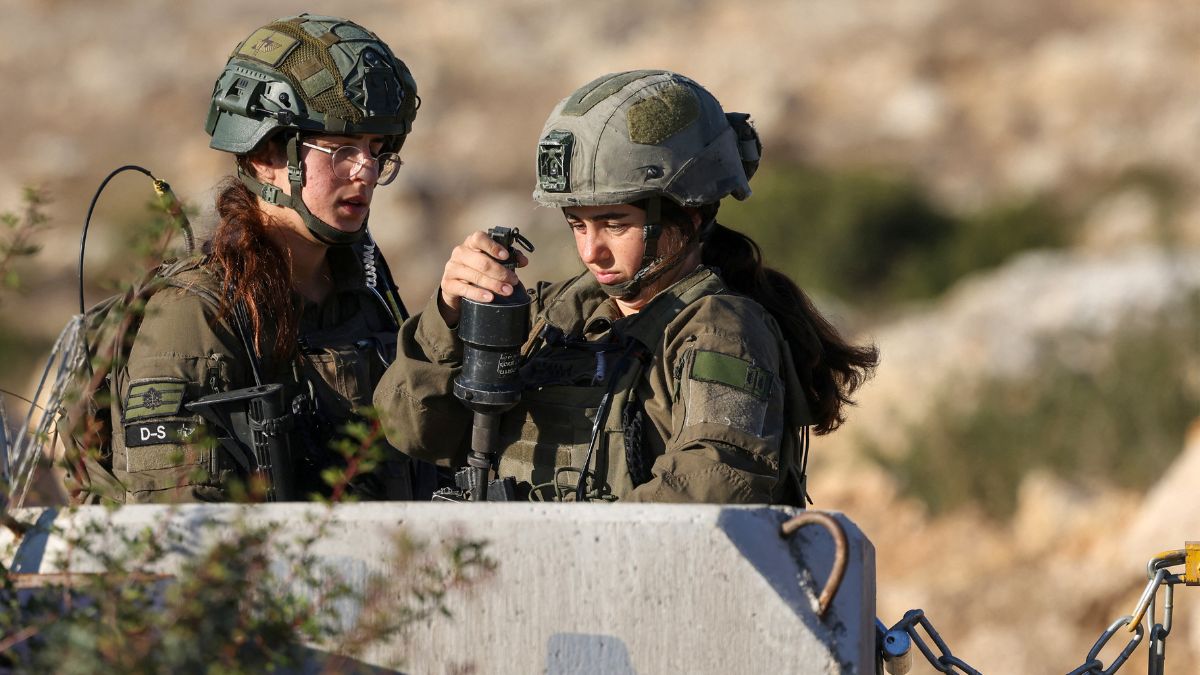 An Israeli security forces member loads a tear gas launcher as they block Palestinians from reaching their land to harvest olives in the occupied West Bank village of Kobar, near Ramallah, on October 18, 2025.- AFP An Israeli security forces member loads a tear gas launcher as they block Palestinians from reaching their land to harvest olives in the occupied West Bank village of Kobar, near Ramallah, on October 18, 2025.- AFP