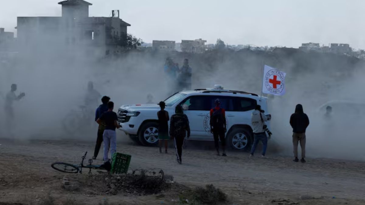 Palestinians gather around a Red Cross vehicle transporting hostages as part of a ceasefire and hostages-prisoners swap deal between Hamas and Israel, in the southern Gaza Strip, October 13. REUTERS Palestinians gather around a Red Cross vehicle transporting hostages as part of a ceasefire and hostages-prisoners swap deal between Hamas and Israel, in the southern Gaza Strip, October 13. REUTERS