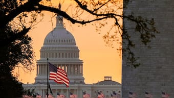 American flags fly in front of the U.S. Capitol at sunrise, Wednesday, Oct. 1, 2025, in Washington. (AP Photo)