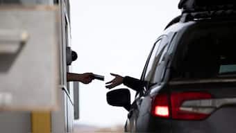 A border patrol officer collects a traveller's passport at the Canada Border Service Agency border crossing with the United States in Stanstead, Que.