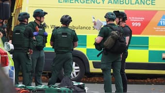 mergency personnel work at the scene following an incident outside a synagogue in north Manchester