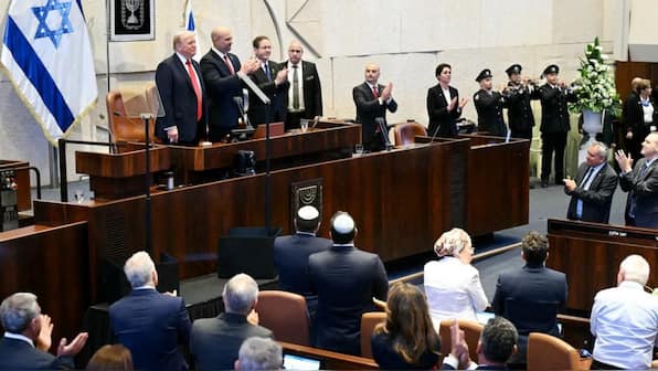 WATCH: Israeli lawmakers hold up signs, Knesset shows them out during Trump address