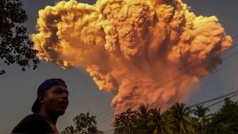 A villager watches the eruption of Mount Lewotobi Laki-Laki as seen from Talibura village in Sikka, East Nusa Tenggara, on June 17, 2025 [AFP]
