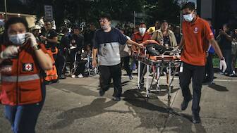 Medical workers bring a resident outside after a strong earthquake struck Cebu City, central Philippines, on Tuesday Sept. 30, 2025. AP