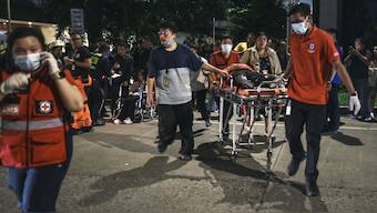 Medical workers bring a resident outside after a strong earthquake struck Cebu City, central Philippines, on Tuesday Sept. 30, 2025. AP