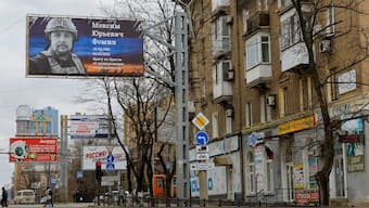 A view shows a board with a poster placed to pay tribute to Russian military blogger Maxim Fomin widely known by the name of Vladlen Tatarsky, who was recently killed in a bomb attack in a St Petersburg cafe, in the course of Russia-Ukraine conflict in the city centre of Donetsk, Russian-controlled Ukraine, April 4, 2023. Reuters