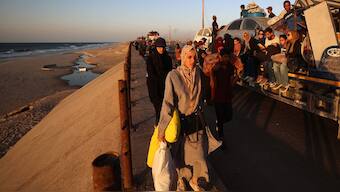 Displaced Palestinians move with their belongings southwards on a road in the Nuseirat refugee camp area in the central Gaza Strip. AFP
