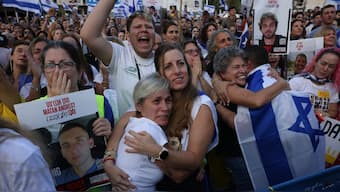Israelis react as they wait for the release of Israelis still held in Gaza at Hostage Square in Tel Aviv early on October 13, 2025. AFP