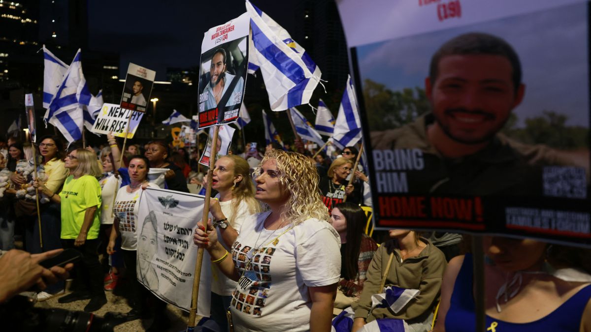 People holding up portraits of Israeli hostages held in Gaza and waving Israeli flags gather at Hostage Square in Tel Aviv early on October 13, 2025. Hamas is set to release all surviving hostages on October 13. AFP People holding up portraits of Israeli hostages held in Gaza and waving Israeli flags gather at Hostage Square in Tel Aviv early on October 13, 2025. Hamas is set to release all surviving hostages on October 13. AFP