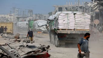 Trucks carry aid for Palestinians, amid a ceasefire between Israel and Hamas in Gaza, in Khan Younis, in the southern Gaza Strip. However, Israel has said that it will cut the number of trucks allowed owing to the delay in releasing the bodies of the dead hostages. Reuters