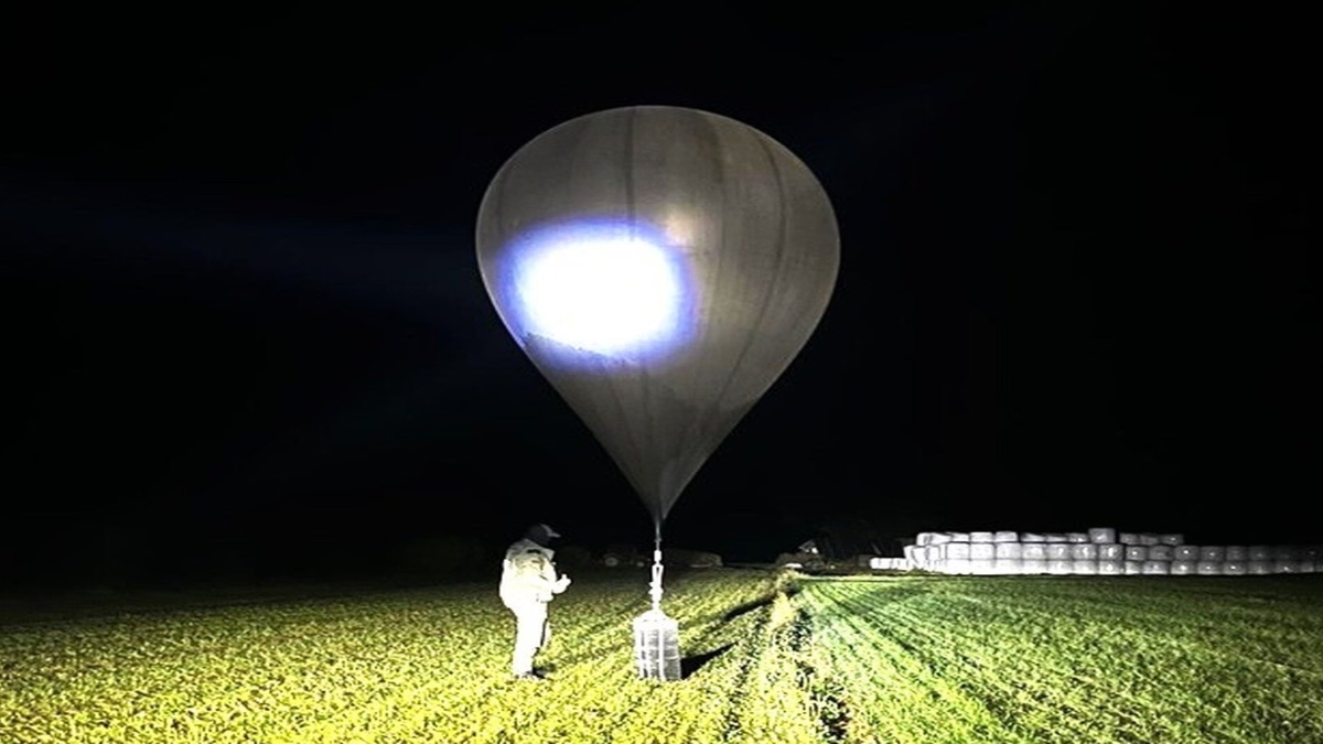 A border officer inspects a balloon in a photo issued earlier this month. Lithuania’s crisis management centre said ‘tens of balloons’ were detected by radar on Friday. AP file A border officer inspects a balloon in a photo issued earlier this month. Lithuania’s crisis management centre said ‘tens of balloons’ were detected by radar on Friday. AP file