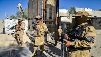 Armed Taliban security personnel keep guard near the closed gate of the zero point border crossing between Afghanistan and Pakistan at Spin Boldak district in Kandahar province. Afghanistan and Pakistan said on October 12, they killed dozens of each other's troops during a night of heavy border clashes between the two countries. AFP