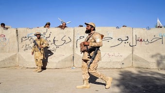 Armed Taliban security personnel keep guard near the closed gate of the zero point border crossing between Afghanistan and Pakistan at Spin Boldak district in Kandahar province. Afghanistan and Pakistan are engaged in violent clashes since the weekend. AFP