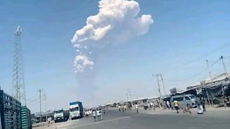 People watch ash billow from an eruption of the long-dormant Hayli Gubbi Volcano in Ethiopia's Afar region, November 23, 2025. Afar Government Communication Bureau via AP
