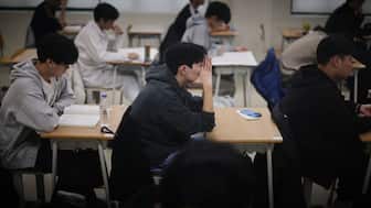 Students wait for the start of the annual college entrance exam, known locally as Suneung, at an exam hall in Seoulon November 13, 2025. AFP