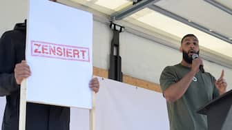 Joe Adade Boateng of the Islamist network Muslim Interactive (MI) speaks on stage beside a poster reading "Censored" during a rally in Hamburg. Reuters