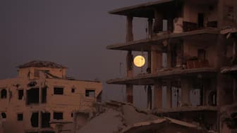 The supermoon rises above destroyed buildings amid a ceasefire between Israel and Hamas in Gaza City. Reuters