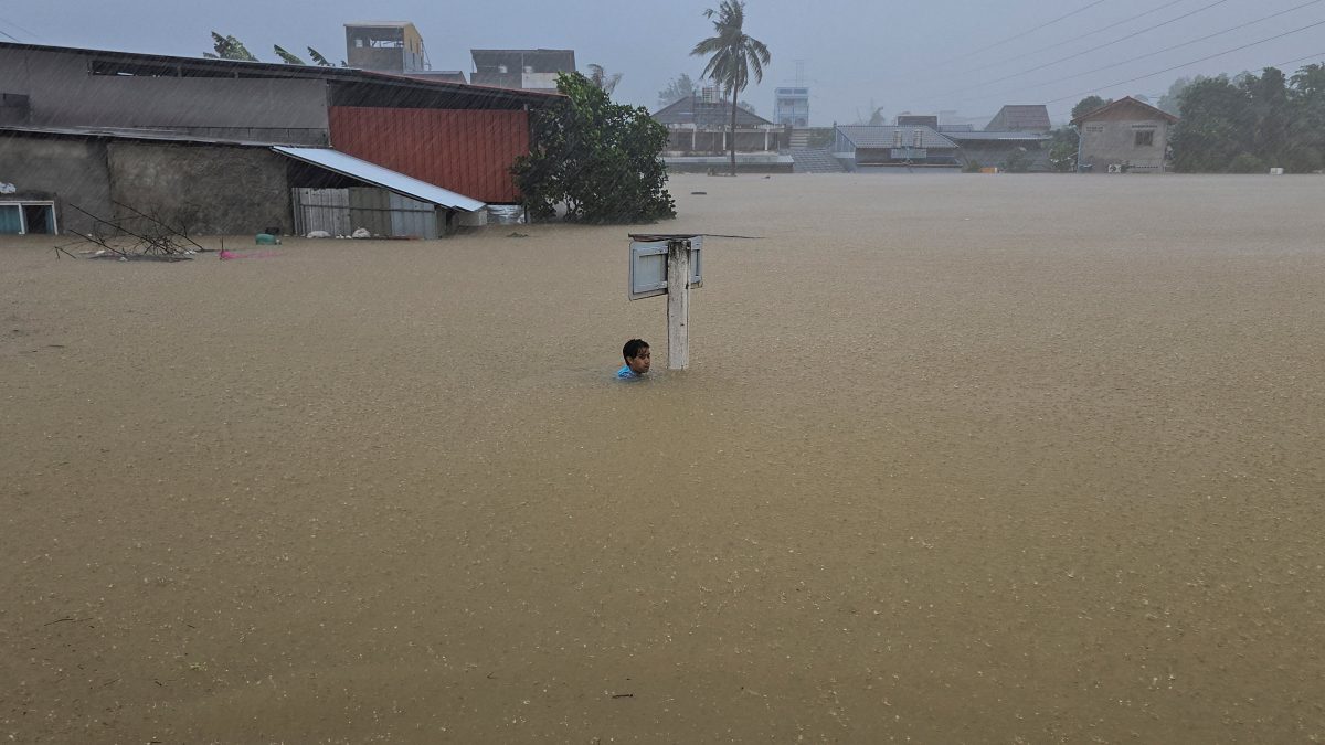 Some places have recorded nearly 400 millimetres (15.7 inches) of accumulated rain. Here, a man clings to a street sign pole in a flooded street after being swept there while going out to get food supplies in the Hat Yai district. Reuters Some places have recorded nearly 400 millimetres (15.7 inches) of accumulated rain. Here, a man clings to a street sign pole in a flooded street after being swept there while going out to get food supplies in the Hat Yai district. Reuters