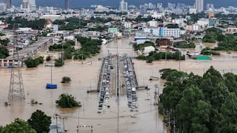 Flash floods have swept homes away near the Thai border with Malaysia, with water reaching rooftops in some parts. A drone view shows cars parked on a bridge to escape floodwaters in a flooded area in Hat Yai district. Reuters