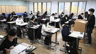 South Korean students wait to take the annual College Scholastic Ability Test, known locally as Suneung, at a school in Seoul (AFP)