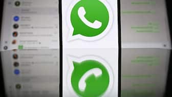 An illustration photograph taken on April 17, 2025 shows Whatsapp web displayed on a laptop screen with a phone displaying the Whatsapp logo, in a residential property in Guildford, south of London. (Photo by Justin TALLIS / AFP)